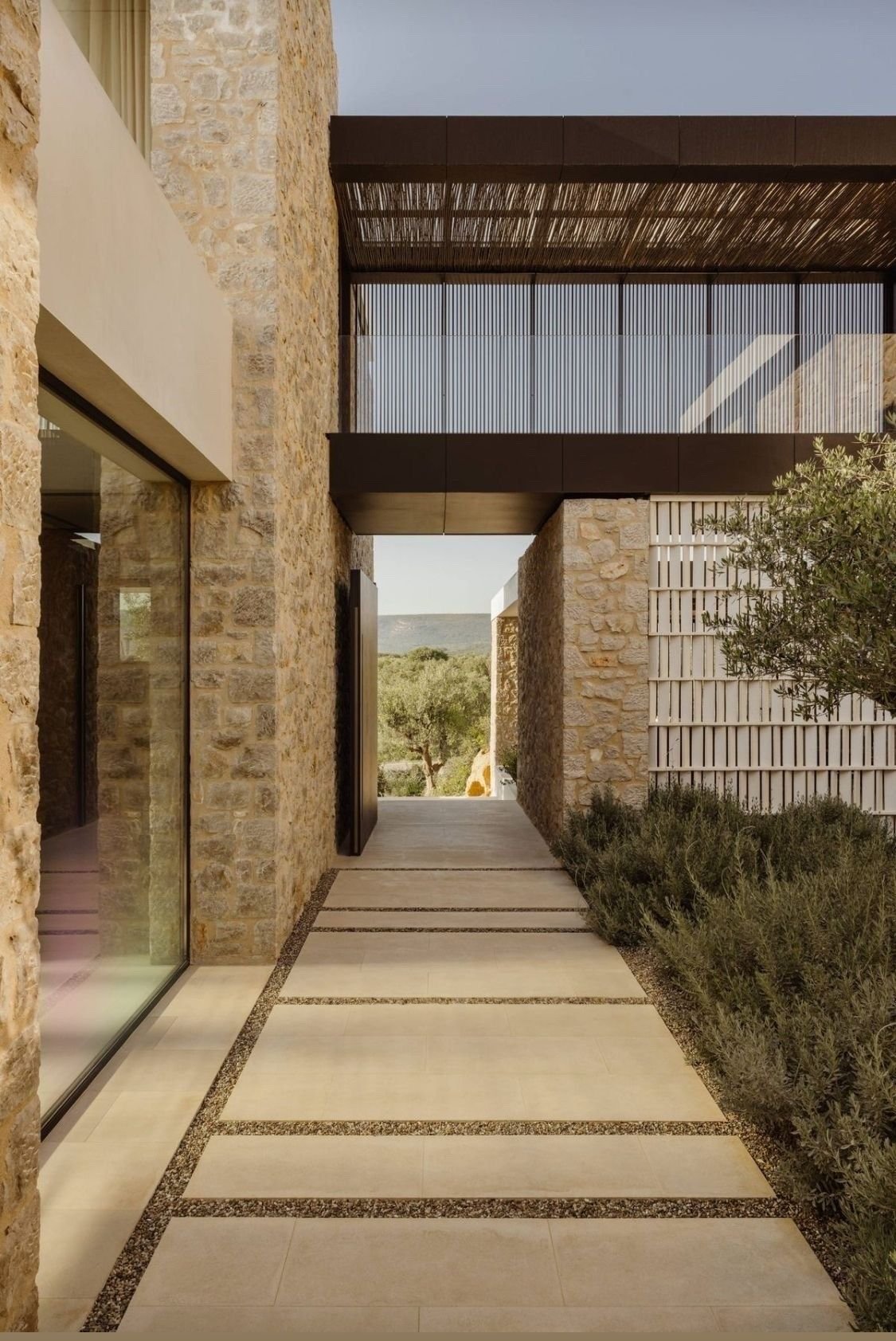 Contemporary stone architecture and minimalist entryway design for exclusive holiday home projects.